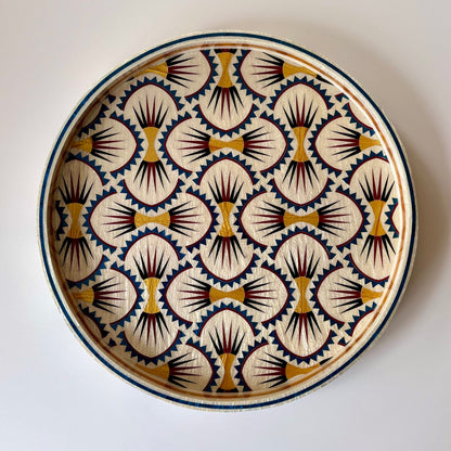 A decorative mother of pearl inlay tray hand made in Egypt with a hand-painted  geometric pattern in cream, navy blue, gold and burgundy on a white background. Alara London 