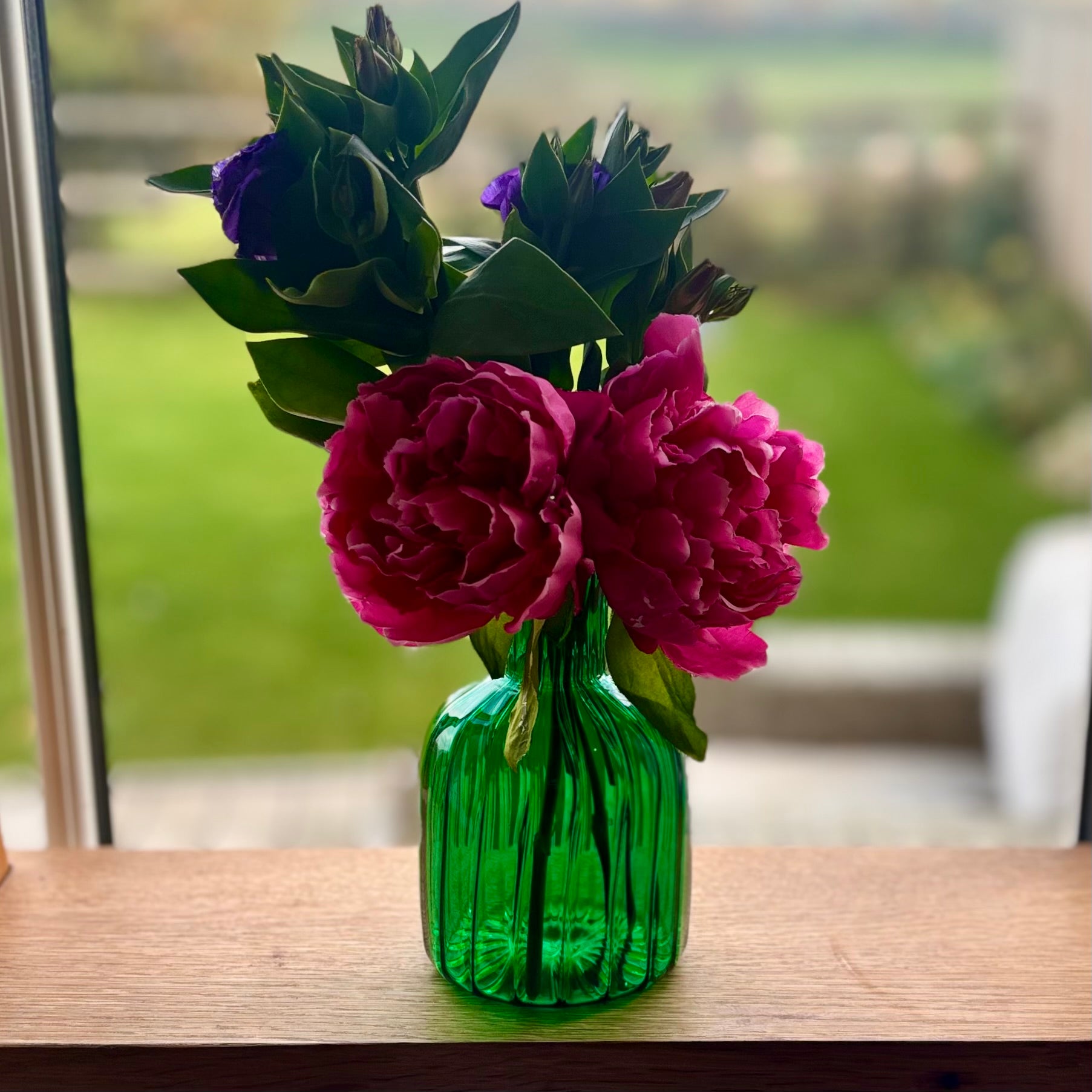 Jade Green vase with pink flowers .